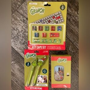 The Grinch Key Caps, Stylus Pen Set, and wireless mouse.